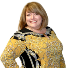 Portrait of a smiling Edie Holderl wearing professional clothes
